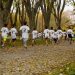 A group of kids participating in a running event in a leafy park in Bursa, Türkiye.